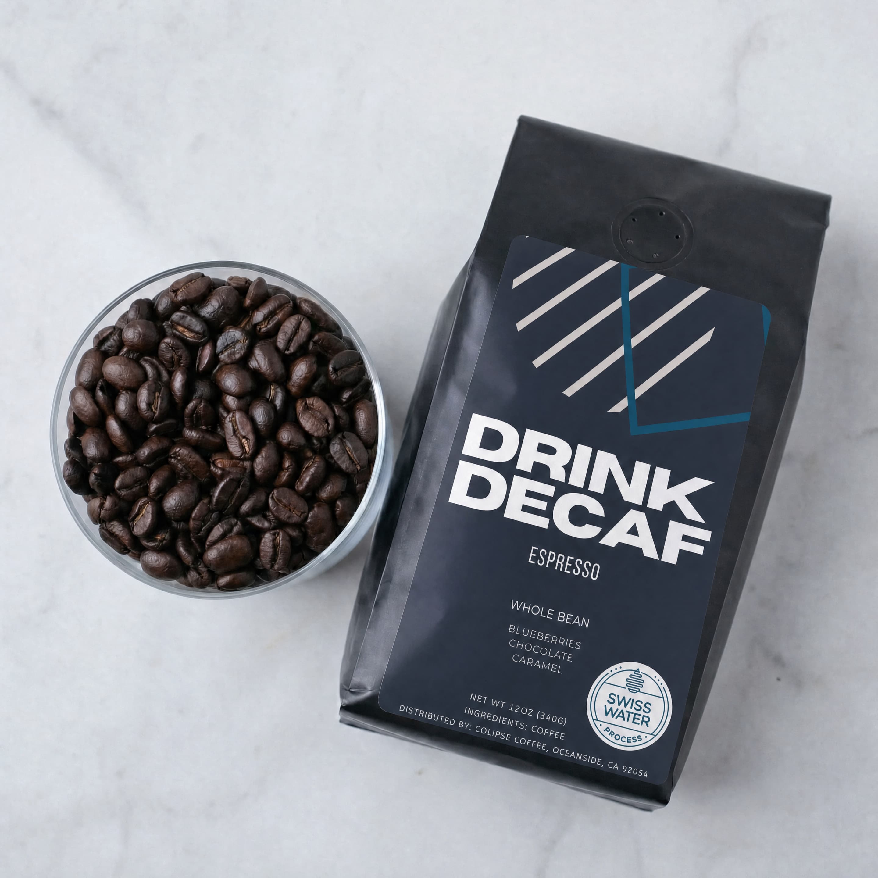 Drink Decaf bag with whole espresso beans in bowl
