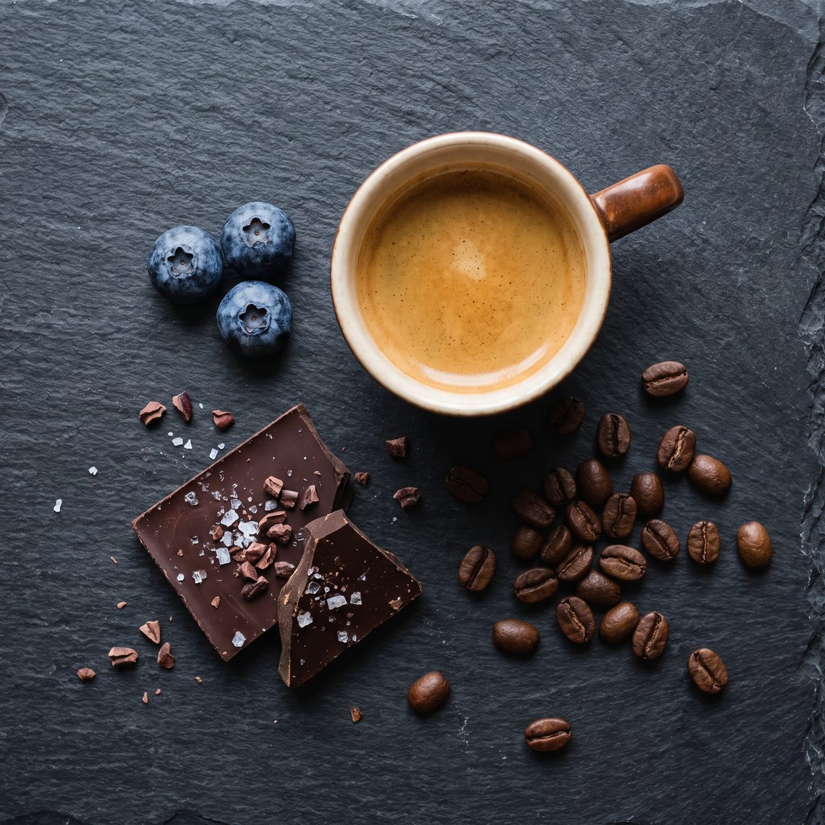 Decaf espresso with dark chocolate and blueberries showing flavor profile of dark roast decaf coffee
